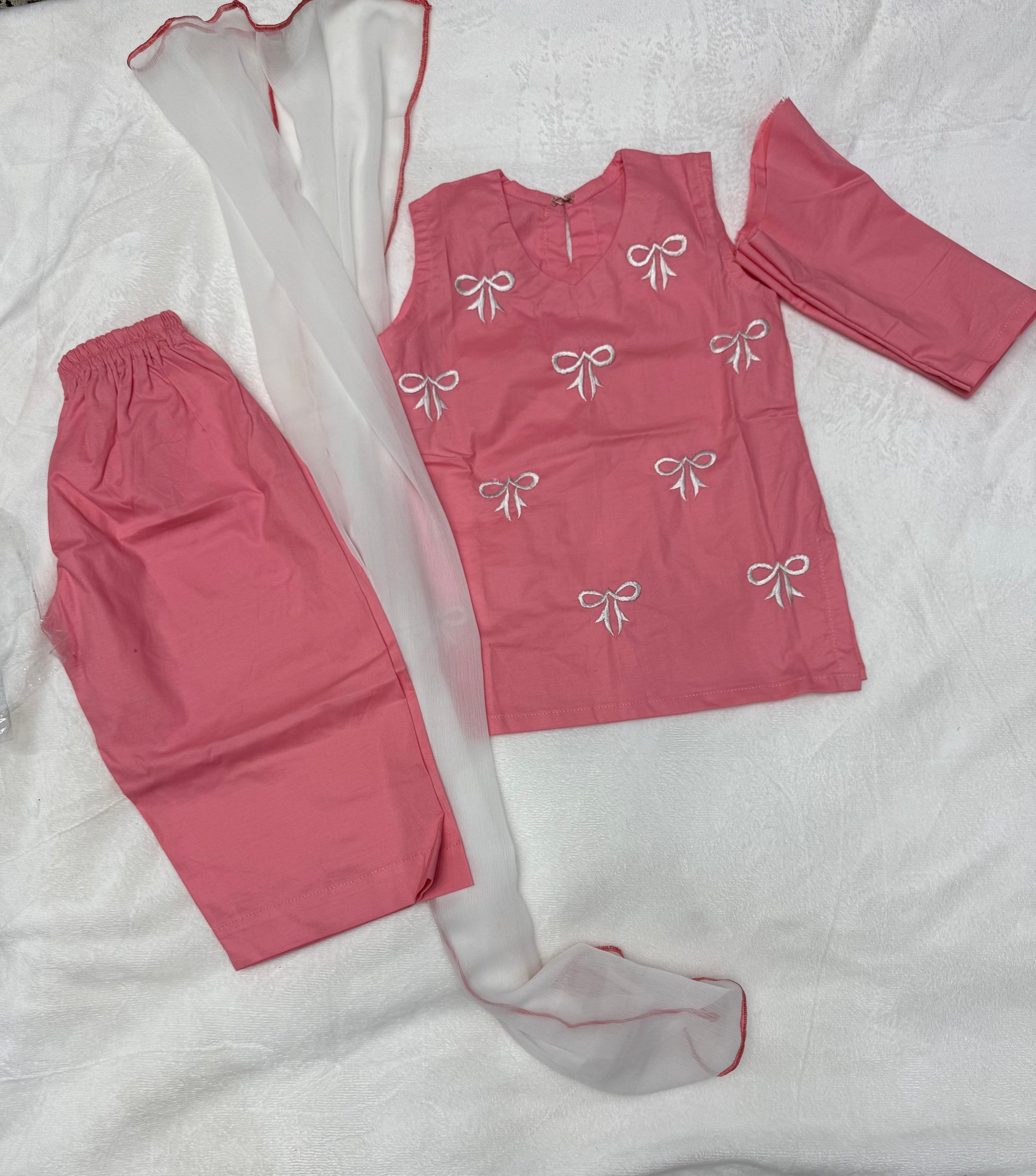 Close-up of embroidered bow detailing on Pink Baby Girl Kurta Set With Dupatta - Pakistani baby clothes UK
