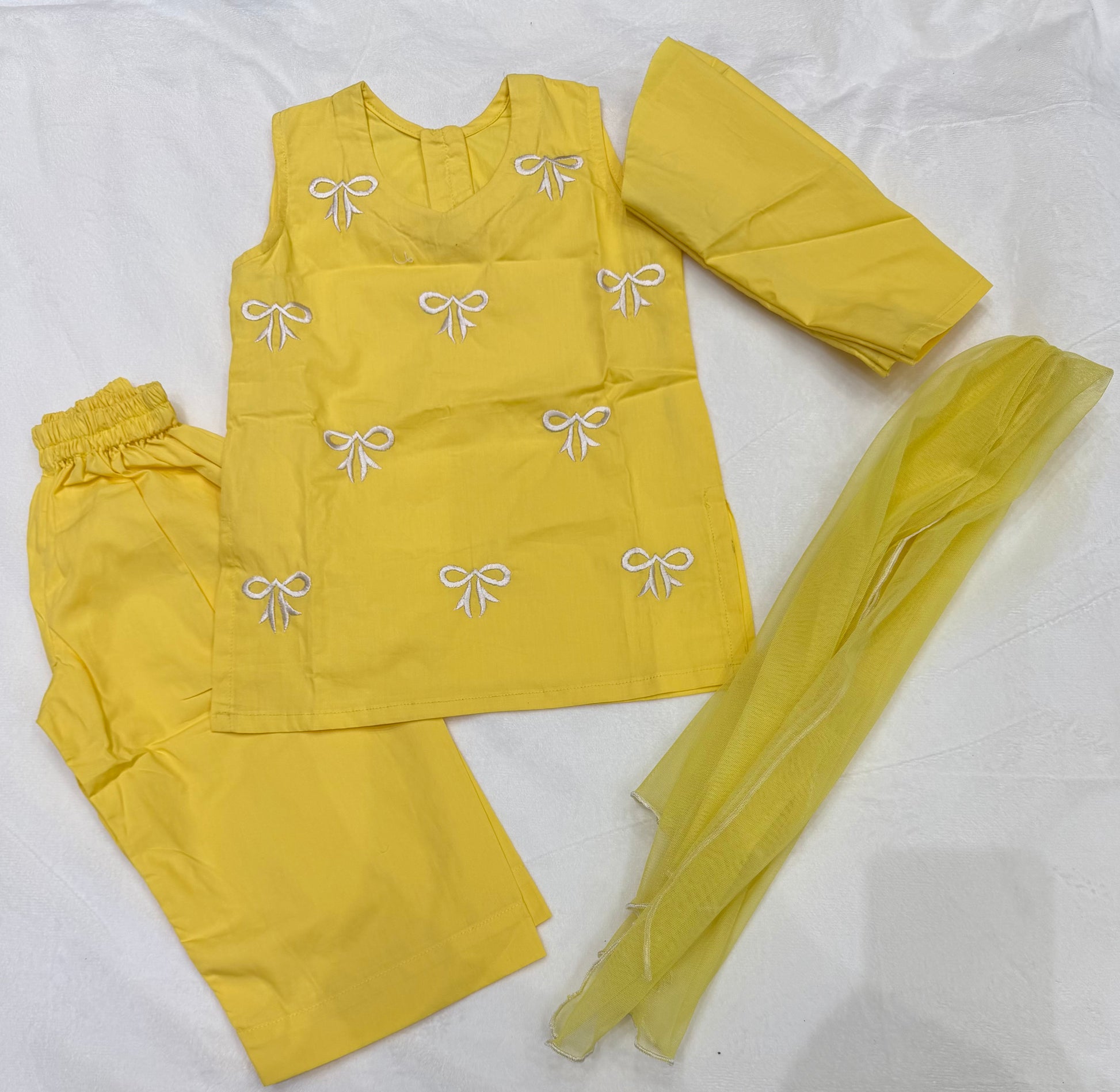 Close-up of embroidered bow detailing on Sunshine Yellow Baby Girl Kurta Set With Dupatta - Pakistani baby clothes UK
